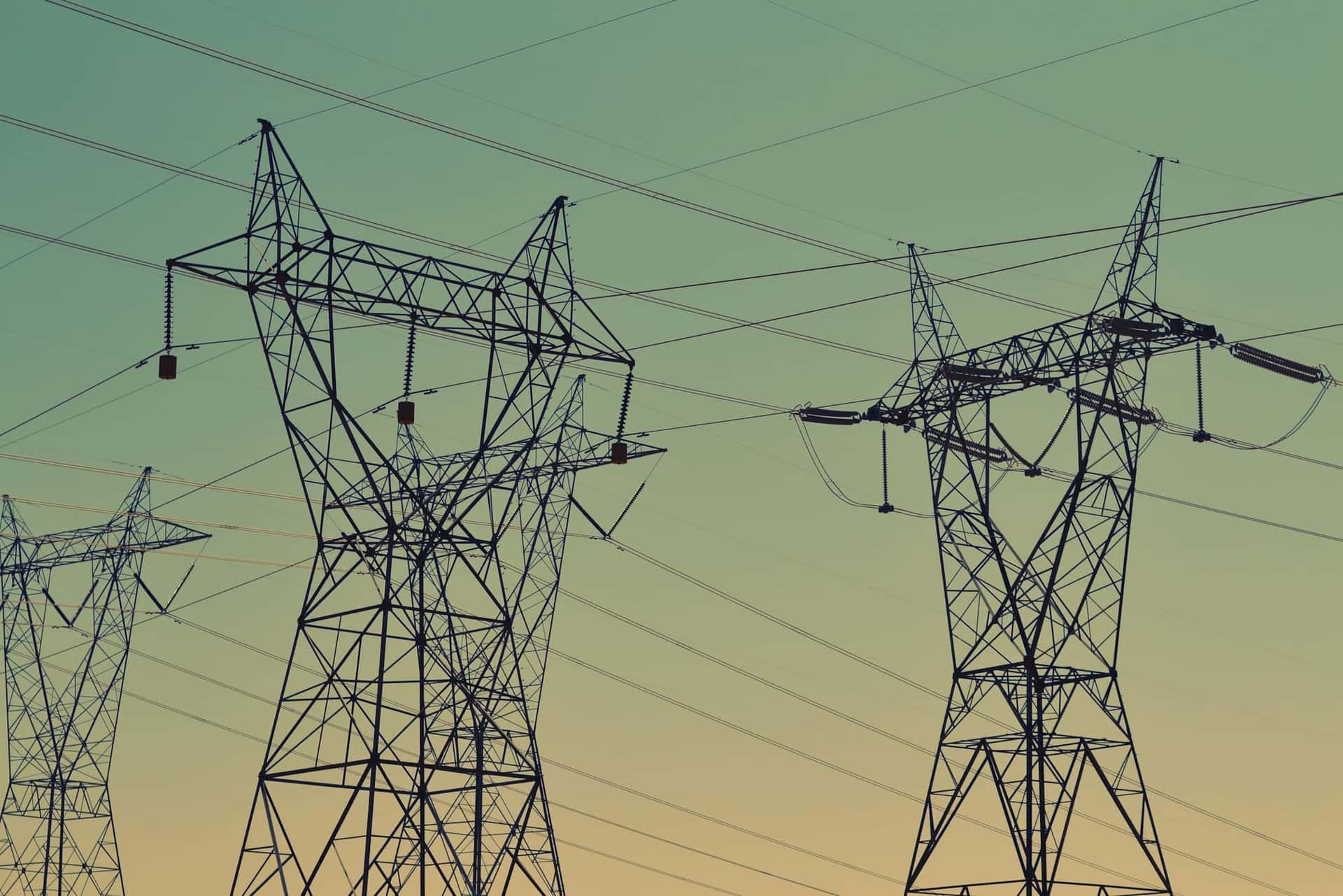 High-voltage transmission towers against the sky